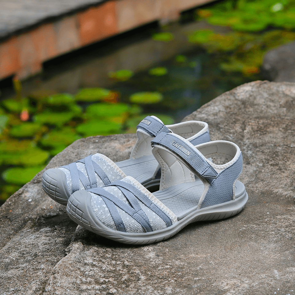 Casual closed toe flat heel women's sandals on rock, perfect for trekking, with hook & loop closure and lightweight EVA insole.